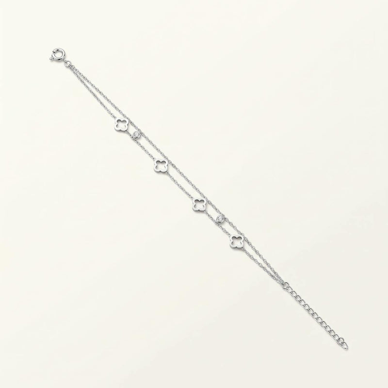 Bracelet double rang argenté à quatre trèfles ajourés sur fond ivoire